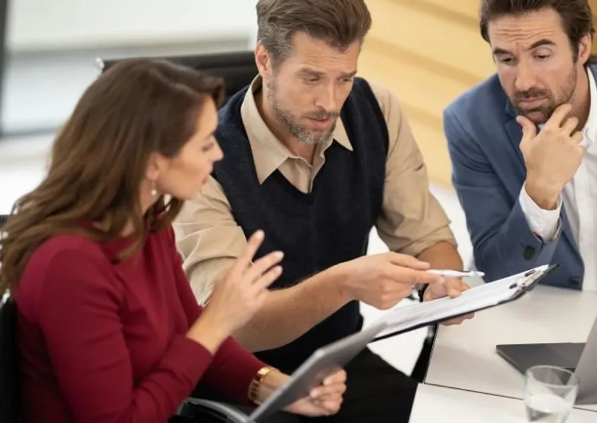 business_team_reviewing_documents_together_dbfb5a19bf