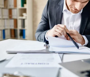 depositphotos_73933359_stock_photo_businessman_reading_documents_e4e7f0780e